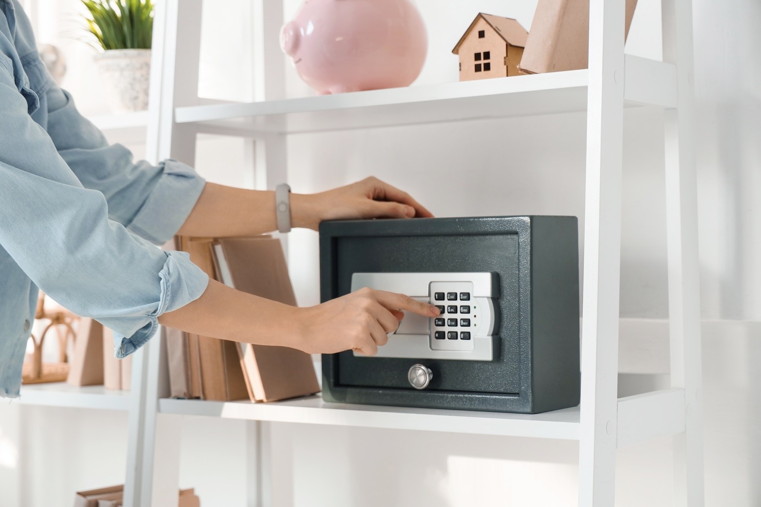 Person entering a combination on a home safe