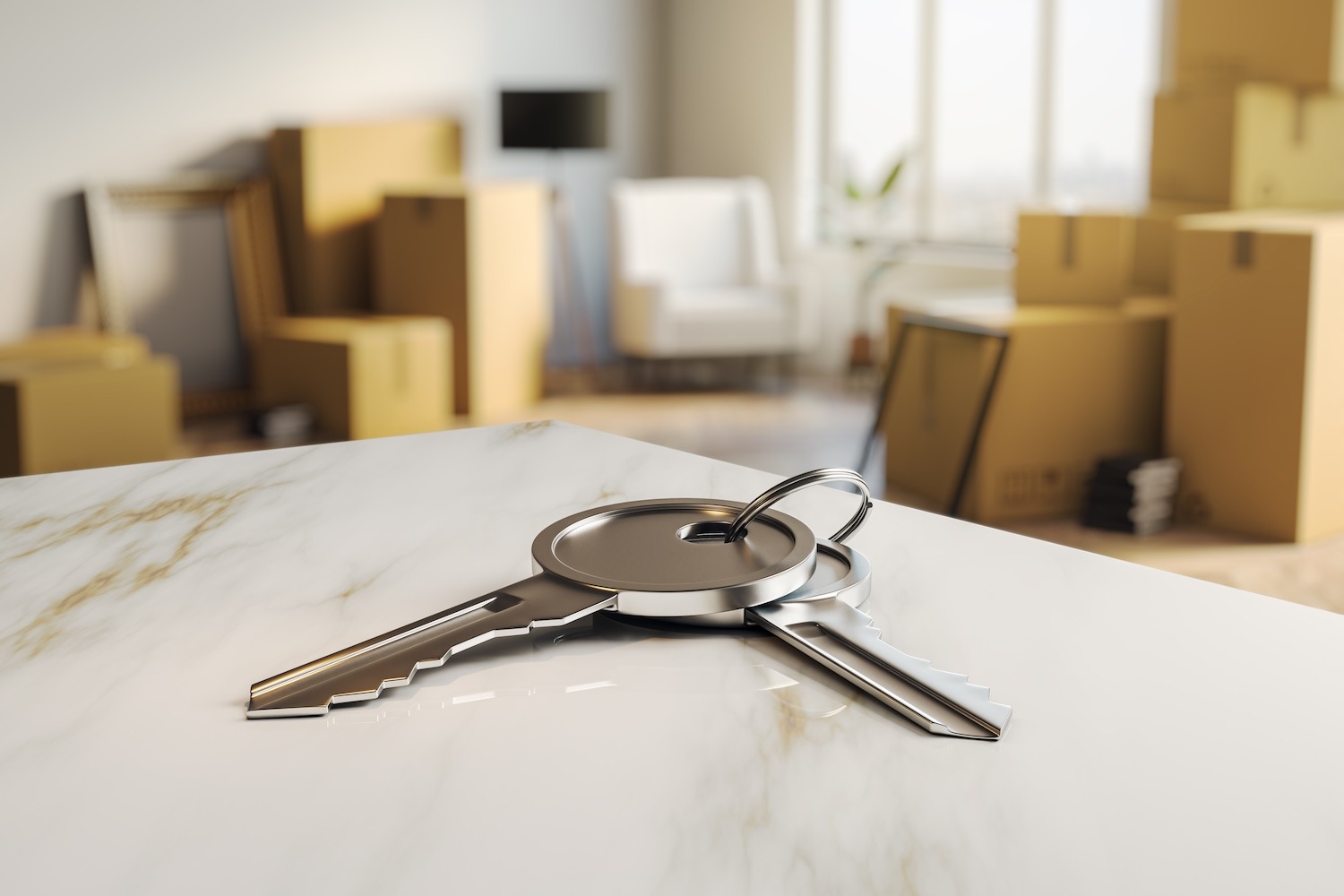 House keys on a countertop with moving boxes in the background of a new home.
