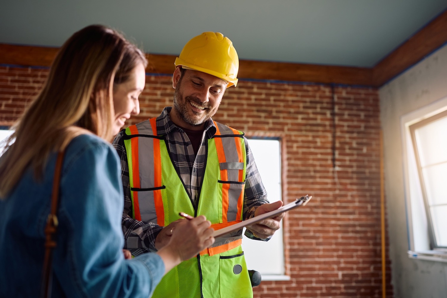 Homeowner reviewing inspection information with a home inspector inside a residential property.