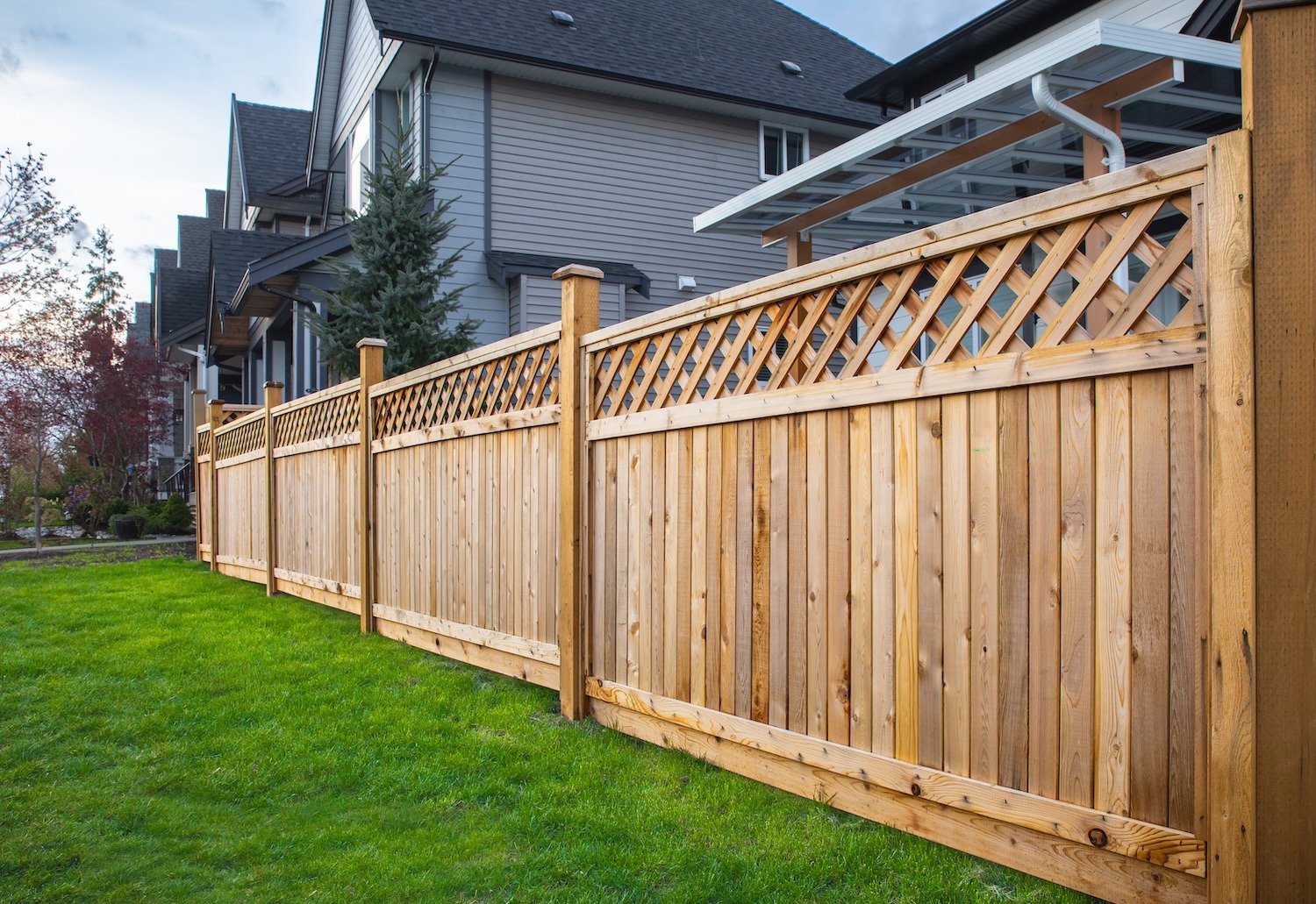 Wooden property boundary fence separating residential homes and backyards
