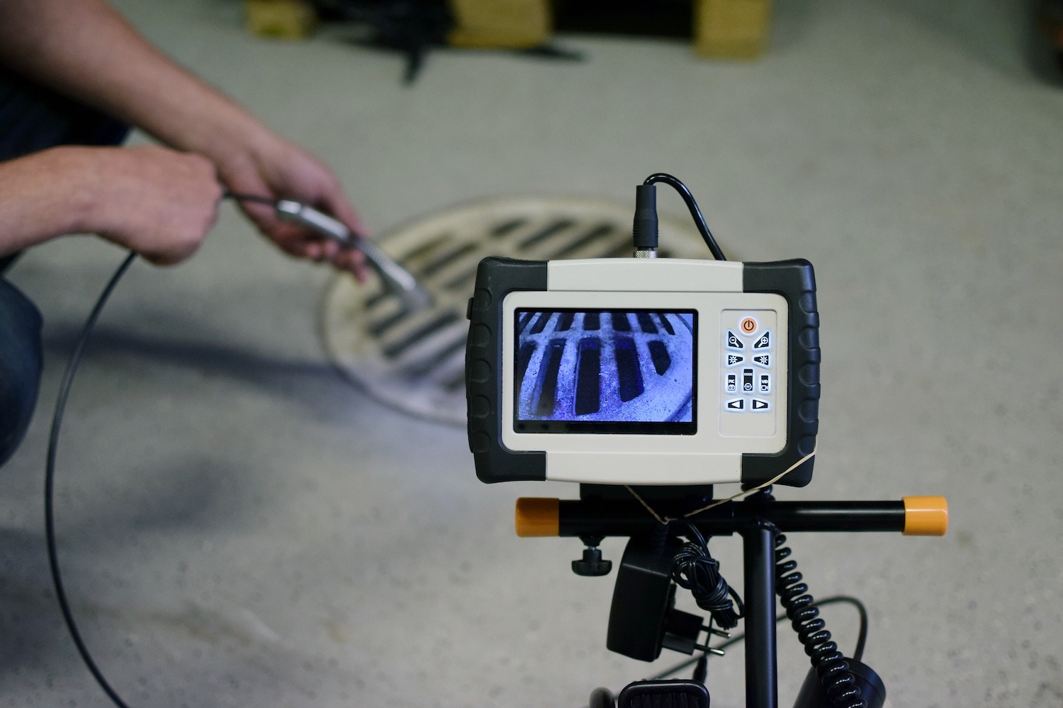 Sanitary drain line being inspected with specialized sewer camera equipment and a video monitor.