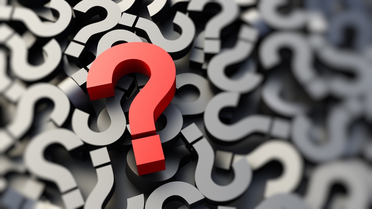 A large question mark positioned above many smaller question marks.