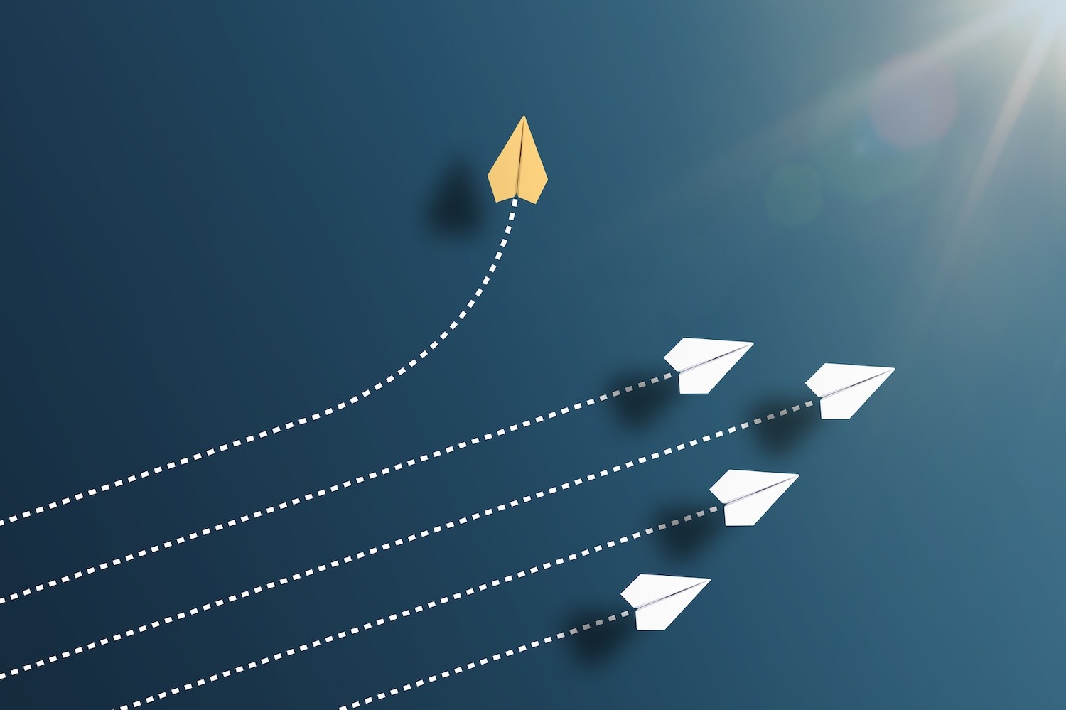 Group of paper airplanes with one airplane moving in a different direction