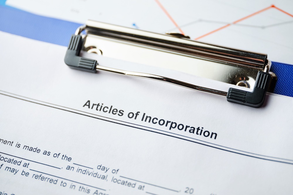 Image of Articles of Incorporation document on a clipboard. Small business concept.