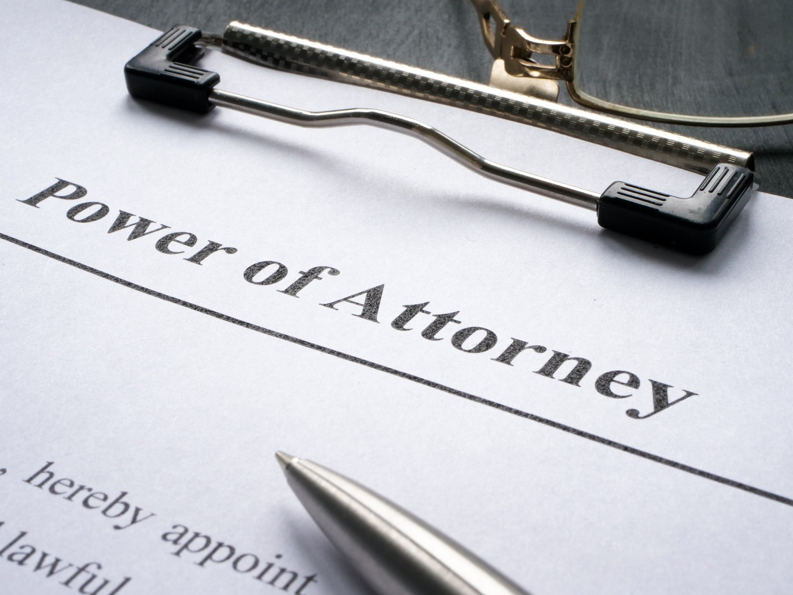 Power of Attorney. Estate Planning. A clipboard with a the top of a white paper with a large Power of Attorney title at the top
